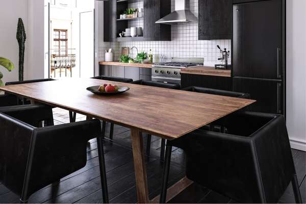 Black Kitchen With A Dining Table
